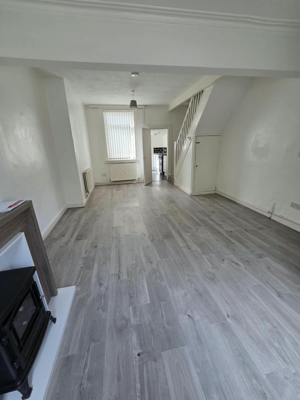 An empty, freshly decorated through-lounge in a Liverpool terraced house, ready for a provider viewing